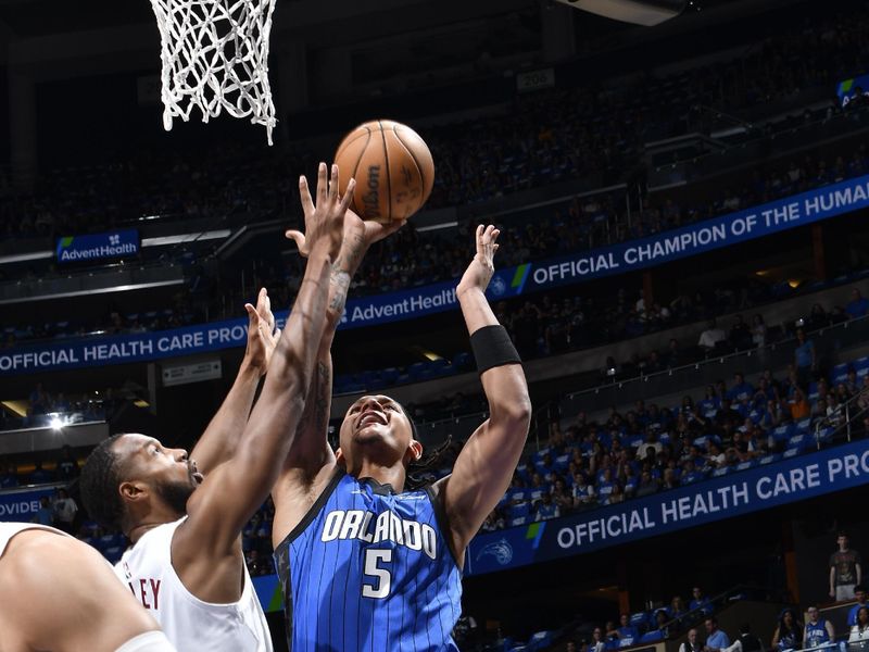 ORLANDO, FL - APRIL 27: Paolo Banchero #5 of the Orlando Magic shoots the ball during the game against the Cleveland Cavaliers during Round 1 Game 4 of the 2024 NBA Playoffs on April 27, 2024 at the Kia Center in Orlando, Florida. NOTE TO USER: User expressly acknowledges and agrees that, by downloading and or using this photograph, User is consenting to the terms and conditions of the Getty Images License Agreement. Mandatory Copyright Notice: Copyright 2024 NBAE (Photo by Fernando Medina/NBAE via Getty Images)