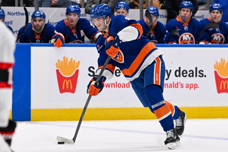 Jan 14, 2025; Elmont, New York, USA;  New York Islanders defenseman Noah Dobson (8) attempts a shot against the Ottawa Senators during the second period at UBS Arena. Mandatory Credit: Dennis Schneidler-Imagn Images