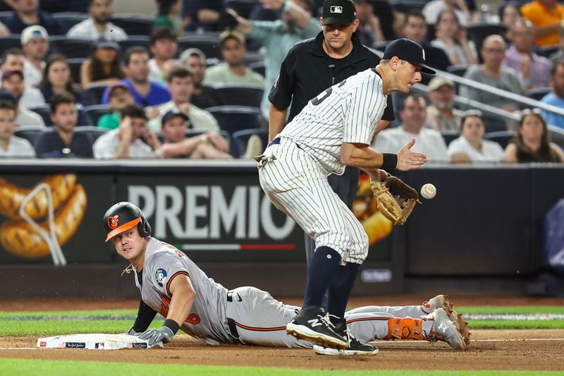 Jun 19, 2024; Bronx, New York, USA;  New York Yankees third baseman DJ LeMahieu (26) handles the ball as Baltimore Orioles first baseman Ryan Mountcastle (6) slides safely into third base in the seventh inning at Yankee Stadium. Mandatory Credit: Wendell Cruz-USA TODAY Sports