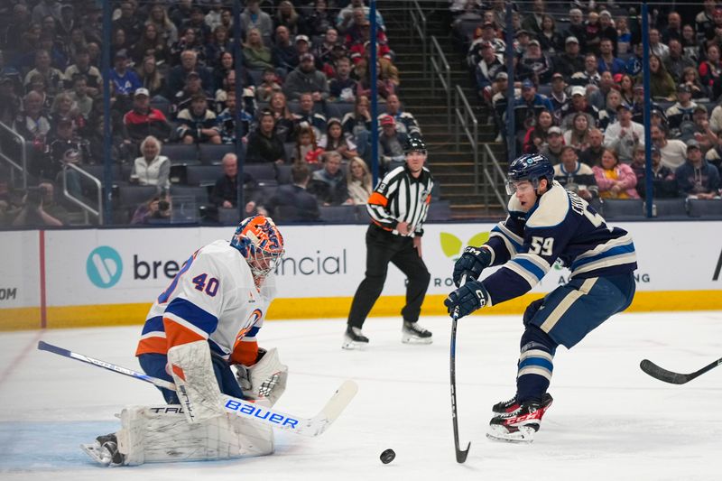 Oct 30, 2024; Columbus, Ohio, USA; Columbus Blue Jackets right wing Yegor Chinakhov (59) shoots the puck against New York Islanders goaltender Semyon Varlamov (40) in the first period at Nationwide Arena. Mandatory Credit: Samantha Madar-Imagn Images