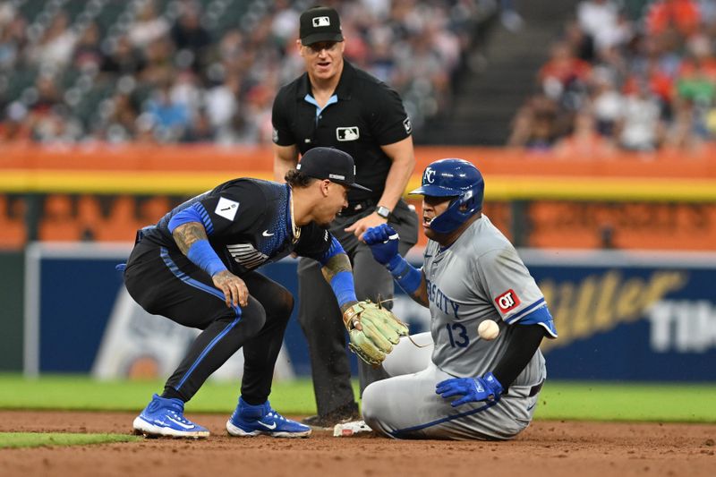 Aug 2, 2024; Detroit, Michigan, USA;  Kansas City Royals first baseman Salvador Perez (13) slides safely into second base ahead of the throw to Detroit Tigers shortstop Javier Baez (28) in the seventh inning at Comerica Park.  Mandatory Credit: Lon Horwedel-USA TODAY Sports