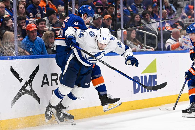 Feb 8, 2024; Elmont, New York, USA; New York Islanders defenseman Ryan Pulock (6) and Tampa Bay Lightning center Tyler Motte (64) collide during the third period at UBS Arena. Mandatory Credit: Dennis Schneidler-USA TODAY Sports