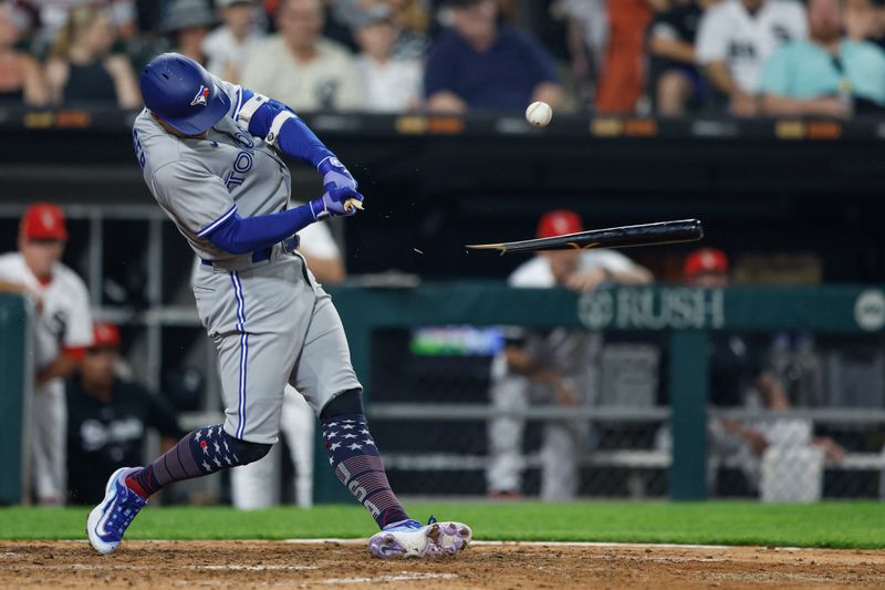 Jul 4, 2023; Chicago, Illinois, USA; Toronto Blue Jays right fielder George Springer (4) breaks his bat against the Chicago White Sox during the seventh inning at Guaranteed Rate Field. Mandatory Credit: Kamil Krzaczynski-USA TODAY Sports