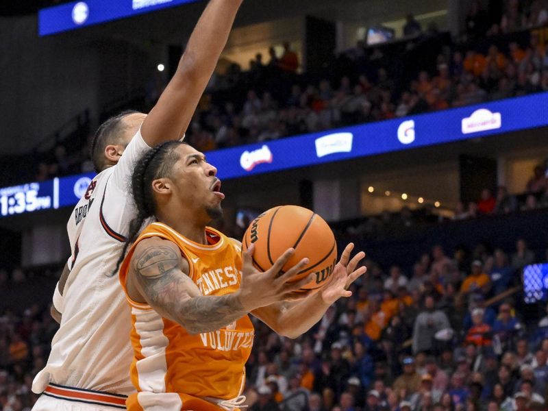 Mar 15, 2025; Nashville, TN, USA;  Tennessee Volunteers guard Zakai Zeigler (5) lays the ball in under the arm of Auburn Tigers forward Johni Broome (4) during the second half at Bridgestone Arena. Mandatory Credit: Steve Roberts-Imagn Images