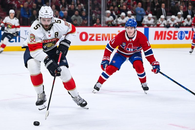 Jan 8, 2026; Montreal, Quebec, CAN; Florida Panthers defenseman Aaron Ekblad (5) defends the puck against Montreal Canadiens right wing Cole Caufield (13) during the first period at Bell Centre. Mandatory Credit: David Kirouac-Imagn Images