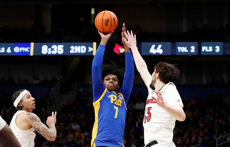 Feb 17, 2024; Pittsburgh, Pennsylvania, USA;  Pittsburgh Panthers guard Carlton Carrington (7) shoots against Louisville Cardinals forward Danilo Jovanovich (13) during the second half at the Petersen Events Center. Pittsburgh won 86-59. Mandatory Credit: Charles LeClaire-USA TODAY Sports