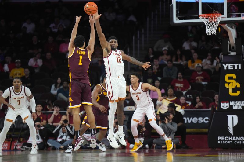 Feb 15, 2025; Los Angeles, California, USA; Minnesota Golden Gophers guard Isaac Asuma (1) shoots the ball against Southern California Trojans forward Rashaun Agee (12) in the second half at the Galen Center. Mandatory Credit: Kirby Lee-Imagn Images
