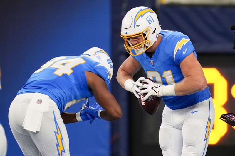 Los Angeles Chargers tight end Will Dissly (81) celebrates his touchdown catch with tight end Stone Smartt (84) during the first half of an NFL football game against the Cincinnati Bengals, Sunday, Nov. 17, 2024, in Inglewood, Calif. (AP Photo/Gregory Bull)