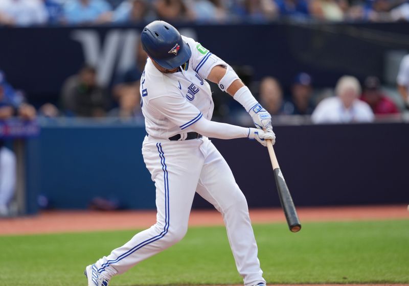 Sep 10, 2023; Toronto, Ontario, CAN; Toronto Blue Jays left fielder Whit Merrifield (15) hits a single against the Kansas City Royals during the eighth inning at Rogers Centre. Mandatory Credit: Nick Turchiaro-USA TODAY Sports