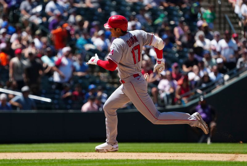 Jun 25, 2023; Denver, Colorado, USA; Los Angeles Angels starting pitcher Shohei Ohtani (17) runs out a triple in the sixth inning against the Colorado Rockies at Coors Field. Mandatory Credit: Ron Chenoy-USA TODAY Sports