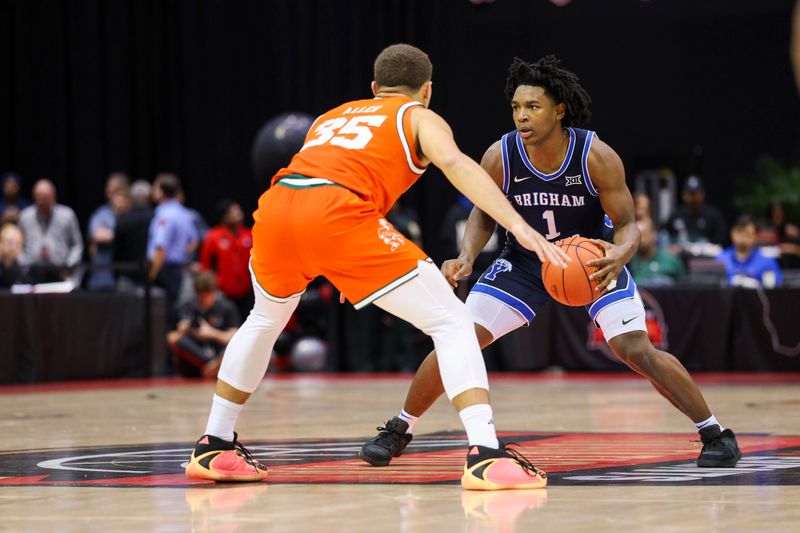 Nov 27, 2025; Kissimmee, Florida, USA; Brigham Young University Cougars guard Robert Wright III (1) is guarded by Miami (FL) Hurricanes guard Dante Allen (35) in the second half at State Farm Field House. Mandatory Credit: Nathan Ray Seebeck-Imagn Images