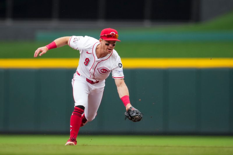 May 4, 2025; Cincinnati, Ohio, USA;  Cincinnati Reds second baseman Matt McLain (9) fields the ball and throws out Washington Nationals outfielder James Wood (29) in the fourth inning inning at Great American Ball Park. Mandatory Credit: Aaron Doster-Imagn Images
