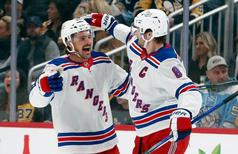 Oct 9, 2024; Pittsburgh, Pennsylvania, USA;  New York Rangers center Sam Carrick (39) celebrates his goal with defenseman Jacob Trouba (8) against the Pittsburgh Penguins during the first period at PPG Paints Arena. Mandatory Credit: Charles LeClaire-Imagn Images