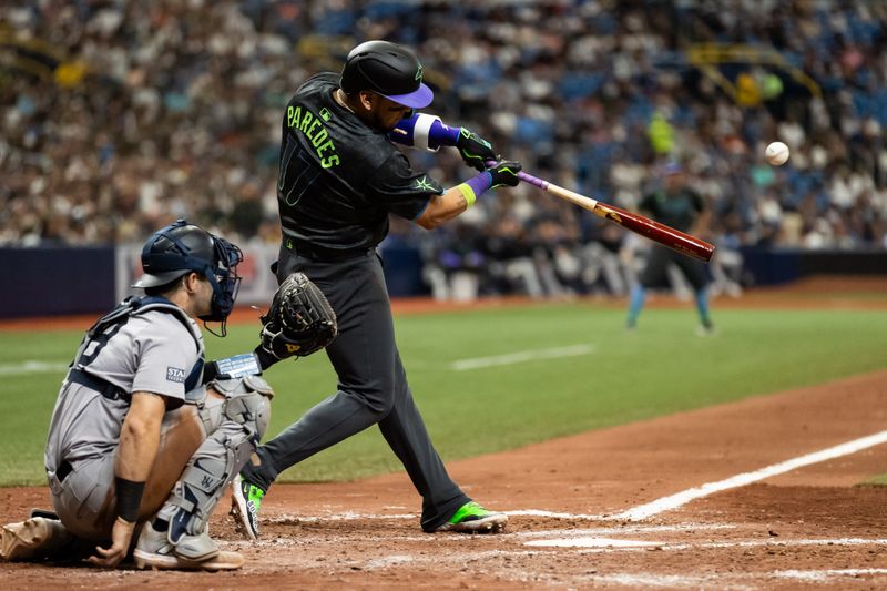 May 11, 2024; St. Petersburg, Florida, USA; Tampa Bay Rays third base Isaac Paredes (17) hits a double against the New York Yankees during the sixth inning at Tropicana Field. Mandatory Credit: Matt Pendleton-USA TODAY Sports