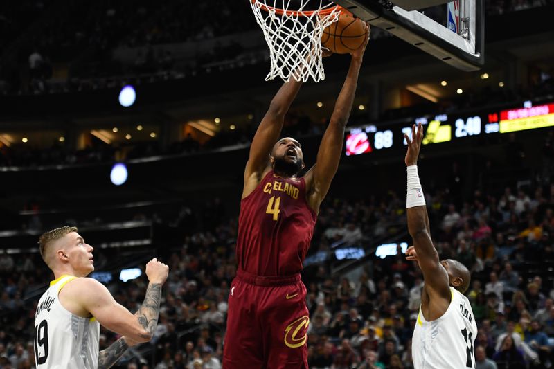 SALT LAKE CITY, UTAH - APRIL 02: Evan Mobley #4 of the Cleveland Cavaliers shoots against Luka Samanic #19 and Kris Dunn #11 of the Utah Jazz during the second half of a game at Delta Center on April 02, 2024 in Salt Lake City, Utah. NOTE TO USER: User expressly acknowledges and agrees that, by downloading and or using this photograph, User is consenting to the terms and conditions of the Getty Images License Agreement. (Photo by Alex Goodlett/Getty Images)