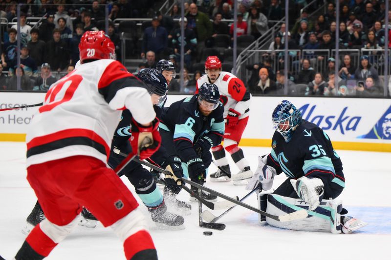 Mar 2, 2026; Seattle, Washington, USA; Seattle Kraken defenseman Adam Larsson (6) and Seattle Kraken goaltender Joey Daccord (35) defends the goal against the Carolina Hurricanes during the third period at Climate Pledge Arena. Mandatory Credit: Steven Bisig-Imagn Images
