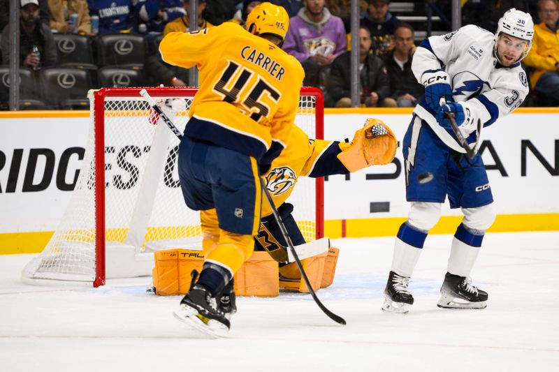 Nov 29, 2024; Nashville, Tennessee, USA;  Tampa Bay Lightning left wing Brandon Hagel (38) deflect the puck as Nashville Predators goaltender Juuse Saros (74) defends during the first period at Bridgestone Arena. Mandatory Credit: Steve Roberts-Imagn Images