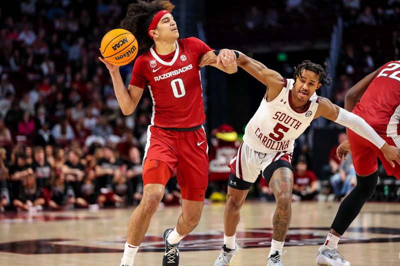 Feb 4, 2023; Columbia, South Carolina, USA; Arkansas Razorbacks guard Anthony Black (0) attempts to drive around South Carolina Gamecocks guard Meechie Johnson (5) in the first half at Colonial Life Arena. Mandatory Credit: Jeff Blake-USA TODAY Sports