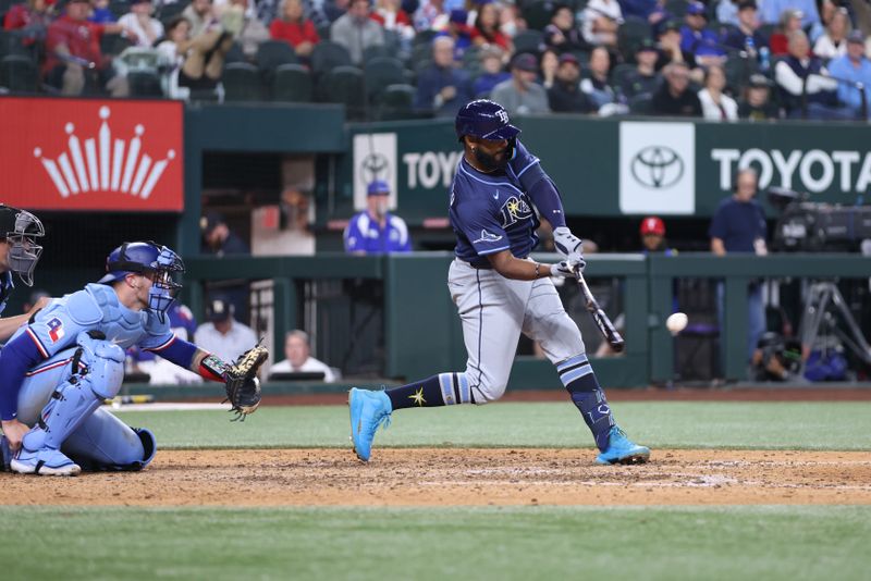 Apr 6, 2025; Arlington, Texas, USA; Tampa Bay Rays shortstop José Caballero (77) drives in a run during the eighth inning against the Texas Rangers at Globe Life Field. Mandatory Credit: Tim Heitman-Imagn Images