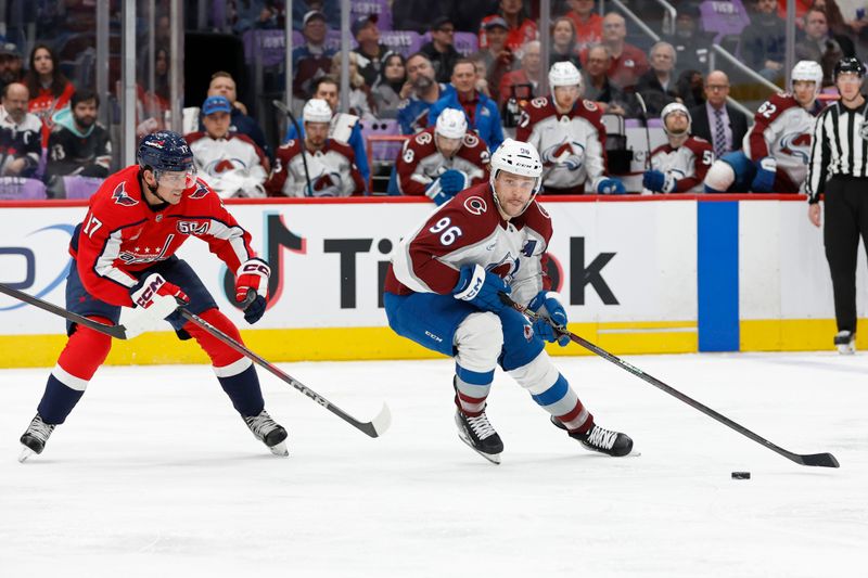 Nov 21, 2024; Washington, District of Columbia, USA; Colorado Avalanche right wing Mikko Rantanen (96) skates with the puck as Washington Capitals center Dylan Strome (17) defends in the second period at Capital One Arena. Mandatory Credit: Geoff Burke-Imagn Images