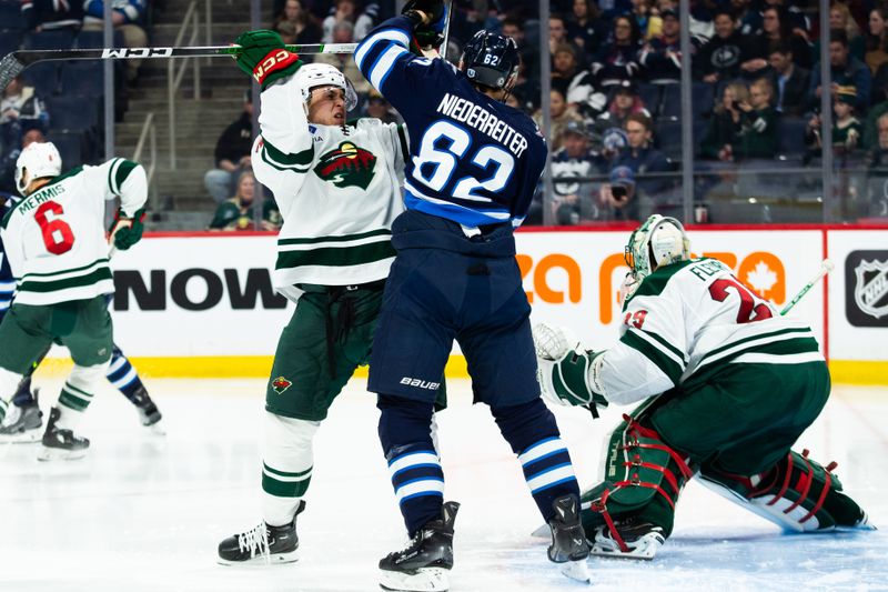 Feb 20, 2024; Winnipeg, Manitoba, CAN; Winnipeg Jets forward Nino Niederreiter (62) jostles for position with Minnesota Wild defenseman Alex Goligoski (33) during the second period at Canada Life Centre. Mandatory Credit: Terrence Lee-USA TODAY Sports