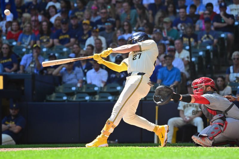 Sep 2, 2024; Milwaukee, Wisconsin, USA; Milwaukee Brewers shortstop Willy Adames (27) hits a 3-run home run in the first inning as St. Louis Cardinals catcher Pedro Pages (43) looks on at American Family Field. Mandatory Credit: Benny Sieu-USA TODAY Sports