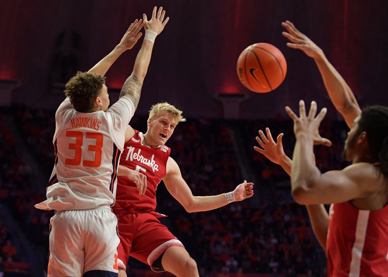 Jan 31, 2023; Champaign, Illinois, USA; Nebraska Cornhuskers guard Sam Griesel (5) passes the ball past Illinois Fighting Illini forward Coleman Hawkins (33) during the second half at State Farm Center. Mandatory Credit: Ron Johnson-USA TODAY Sports