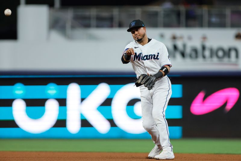 Jun 25, 2023; Miami, Florida, USA; Miami Marlins second baseman Luis Arraez (3) throws the baseball to first baseman Yuli Gurriel (not pictured) to retire Pittsburgh Pirates second baseman Ji Hwan Bae (not pictured) during the eighth inning at loanDepot Park. Mandatory Credit: Sam Navarro-USA TODAY Sports