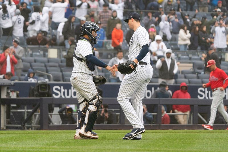 Apr 5, 2023; Bronx, New York, USA; New York Yankees catcher Jose Trevino (39) congratulates New York Yankees pitcher Clay Holmes (35) for getting the save against the Philadelphia Phillies after the game at Yankee Stadium. Mandatory Credit: Gregory Fisher-USA TODAY Sports