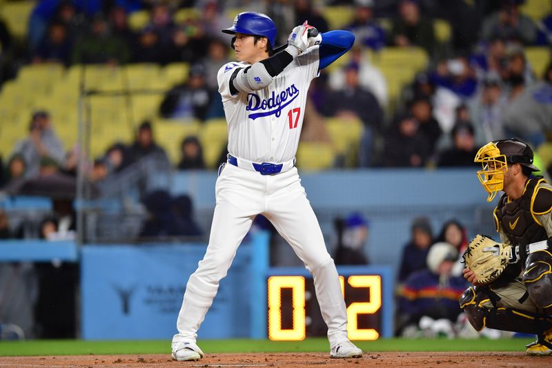 Apr 13, 2024; Los Angeles, California, USA; Los Angeles Dodgers designated hitter Shohei Ohtani (17) hits against the San Diego Padres during the first inning at Dodger Stadium. Mandatory Credit: Gary A. Vasquez-USA TODAY Sports