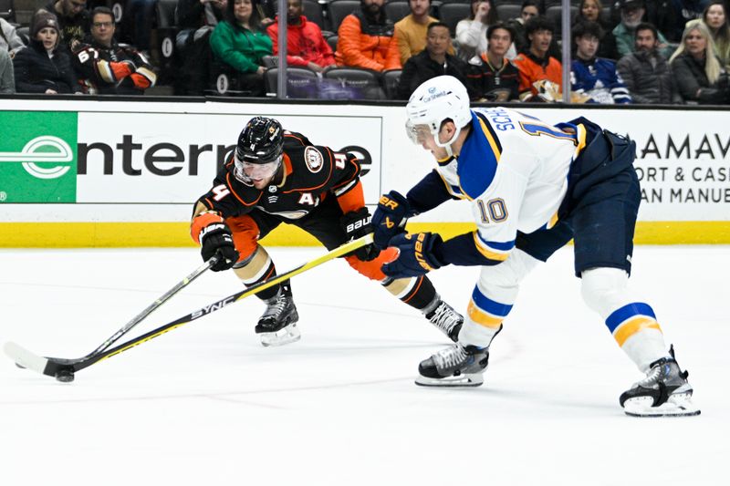 Mar 25, 2023; Anaheim, California, USA; St. Louis Blues center Brayden Schenn (10) handles the puck against Anaheim Ducks defenseman Cam Fowler (4) during the second period at Honda Center. Mandatory Credit: Kelvin Kuo-USA TODAY Sports