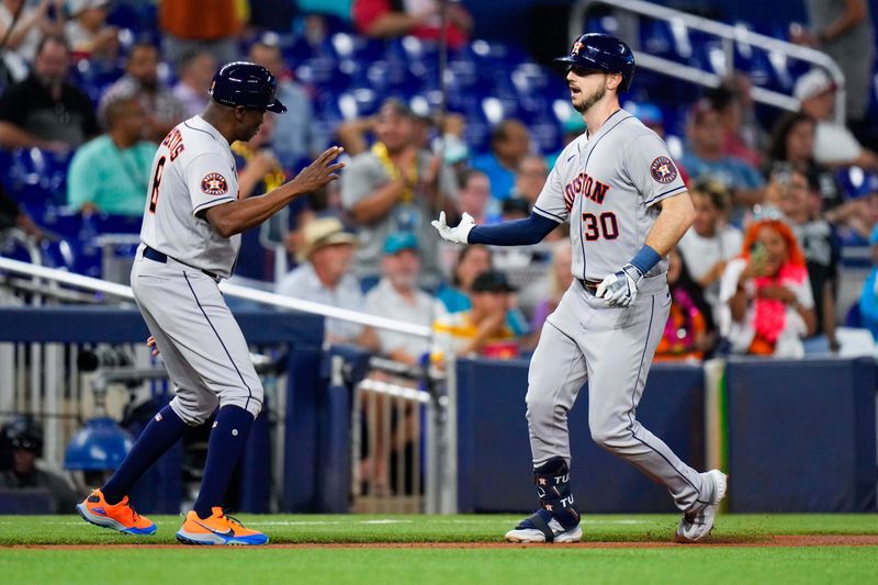 Aug 16, 2023; Miami, Florida, USA; Houston Astros right fielder Kyle Tucker (30) celebrates with Houston Astros third base coach Gary Pettis (8) while rounding the bases after hitting a home run against the Miami Marlins during the first inning at loanDepot Park. Mandatory Credit: Rich Storry-USA TODAY Sports