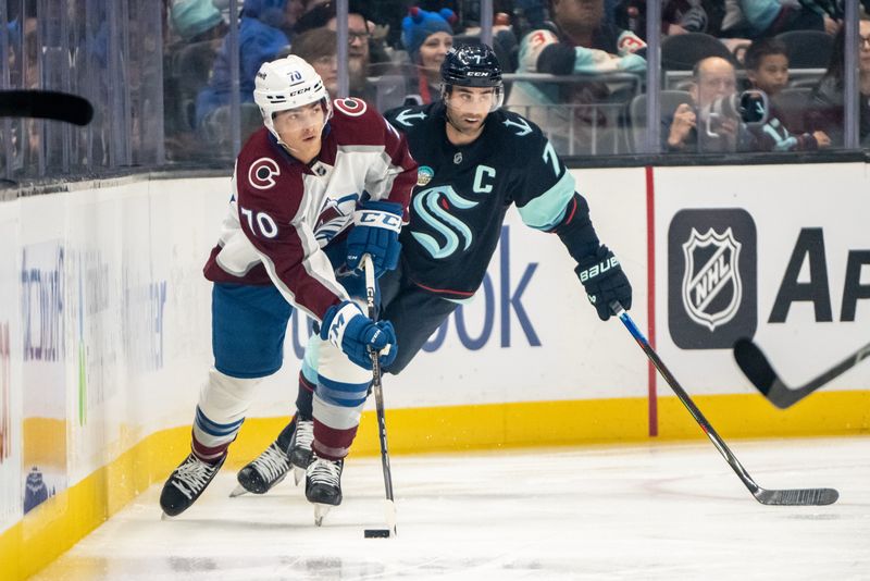 Oct 22, 2024; Seattle, Washington, USA;  Colorado Avalanche defenseman Sam Malinski (70) sktates against Seattle Kraken forward Jordan Eberle (7) during the first period at Climate Pledge Arena. Mandatory Credit: Stephen Brashear-Imagn Images