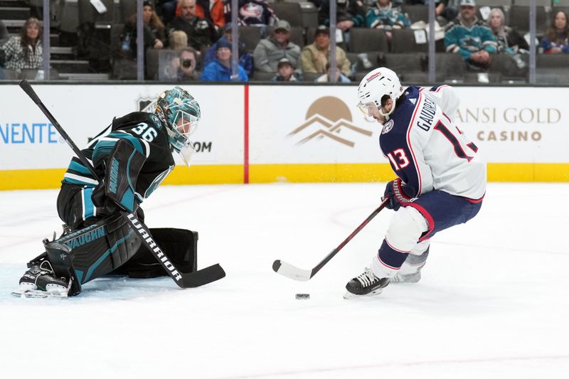 Feb 17, 2024; San Jose, California, USA; Columbus Blue Jackets left wing Johnny Gaudreau (13) skates with the puck against San Jose Sharks goaltender Kaapo Kahkonen (36) during the first period at SAP Center at San Jose. Mandatory Credit: Darren Yamashita-USA TODAY Sports