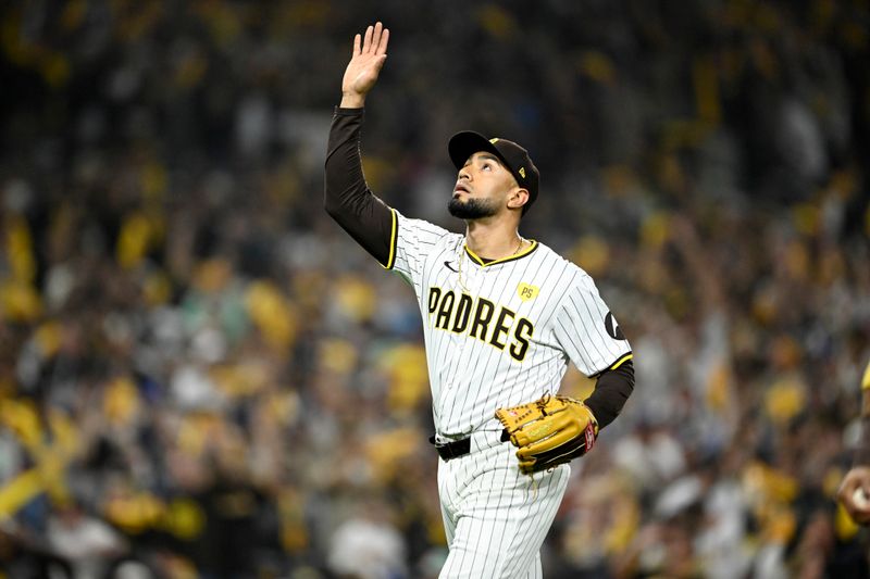 Oct 8, 2024; San Diego, California, USA; San Diego Padres pitcher Robert Suarez (75) reacts after the top of the eighth inning against the Los Angeles Dodgers during game three of the NLDS for the 2024 MLB Playoffs at Petco Park.  Mandatory Credit: Denis Poroy-Imagn Images