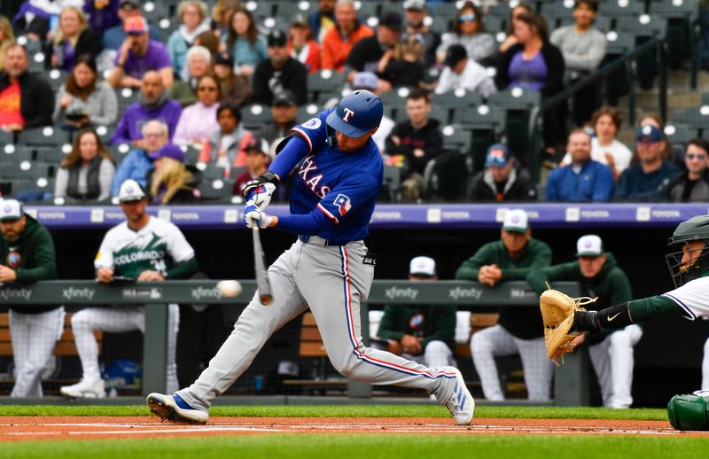 May 11, 2024; Denver, Colorado, USA; Texas Rangers shortstop Corey Seager (5) grounds out against the Colorado Rockies during the first inning at Coors Field. Mandatory Credit: John Leyba-USA TODAY Sports