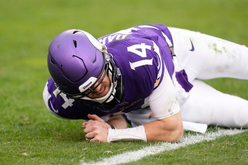 Minnesota Vikings quarterback Sam Darnold (14) goes with an injury during the second half of an NFL football game against the Chicago Bears, Sunday, Nov. 24, 2024, in Chicago. (AP Photo/Erin Hooley)