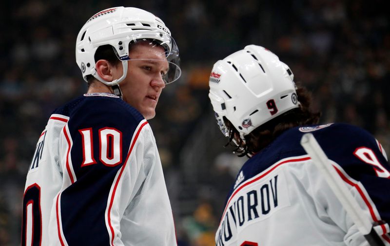 Mar 5, 2024; Pittsburgh, Pennsylvania, USA; Columbus Blue Jackets left wing Dmitri Voronkov (10) talks with defenseman Ivan Provorov (9) against the Pittsburgh Penguins during the first period at PPG Paints Arena. Mandatory Credit: Charles LeClaire-USA TODAY Sports