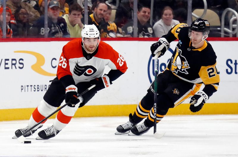 Feb 25, 2024; Pittsburgh, Pennsylvania, USA;  Philadelphia Flyers defenseman Sean Walker (26) moves the puck ahead of Pittsburgh Penguins center Lars Eller (20) during the third period at PPG Paints Arena.  Pittsburgh won 7-6. Mandatory Credit: Charles LeClaire-USA TODAY Sports