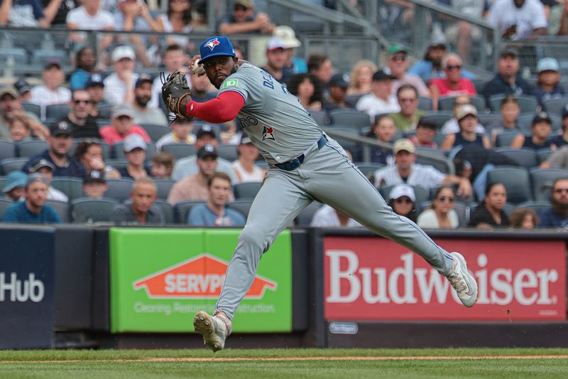 Aug 4, 2024; Bronx, New York, USA; Toronto Blue Jays third baseman Luis De Los Santos (20) throws the ball to first base for an out during the third inning against the New York Yankees at Yankee Stadium. Mandatory Credit: Vincent Carchietta-USA TODAY Sports