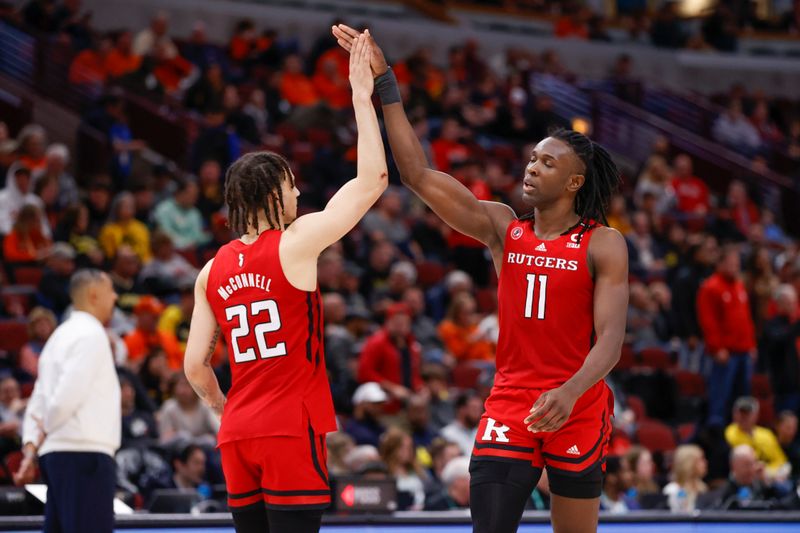 Mar 9, 2023; Chicago, IL, USA; Rutgers Scarlet Knights guard Caleb McConnell (22) and Rutgers Scarlet Knights center Clifford Omoruyi (11) celebrates during the final moments against the Michigan Wolverines at United Center. Mandatory Credit: Kamil Krzaczynski-USA TODAY Sports