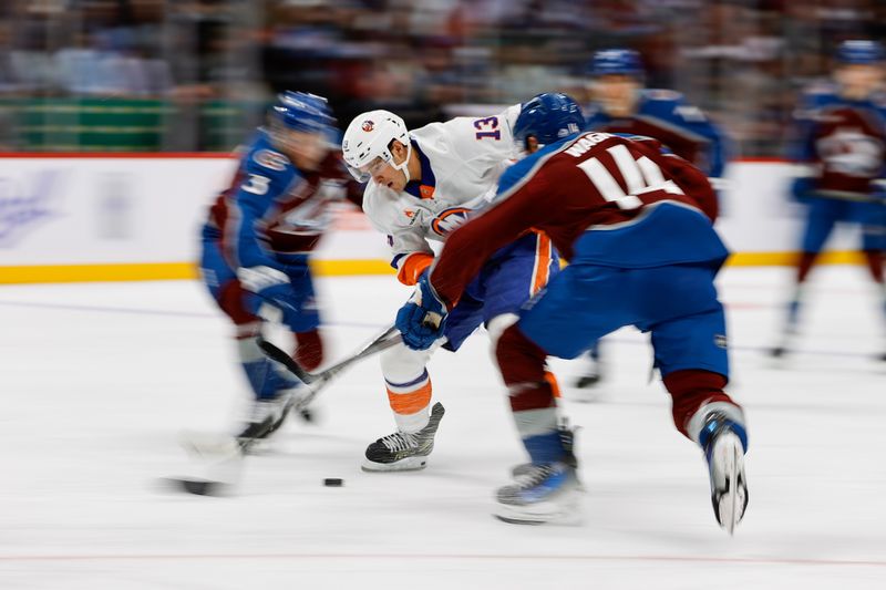 Oct 14, 2024; Denver, Colorado, USA; New York Islanders center Mathew Barzal (13) controls the puck under pressure from Colorado Avalanche right wing Chris Wagner (14) and defenseman John Ludvig (3) in the first period at Ball Arena. Mandatory Credit: Isaiah J. Downing-Imagn Images