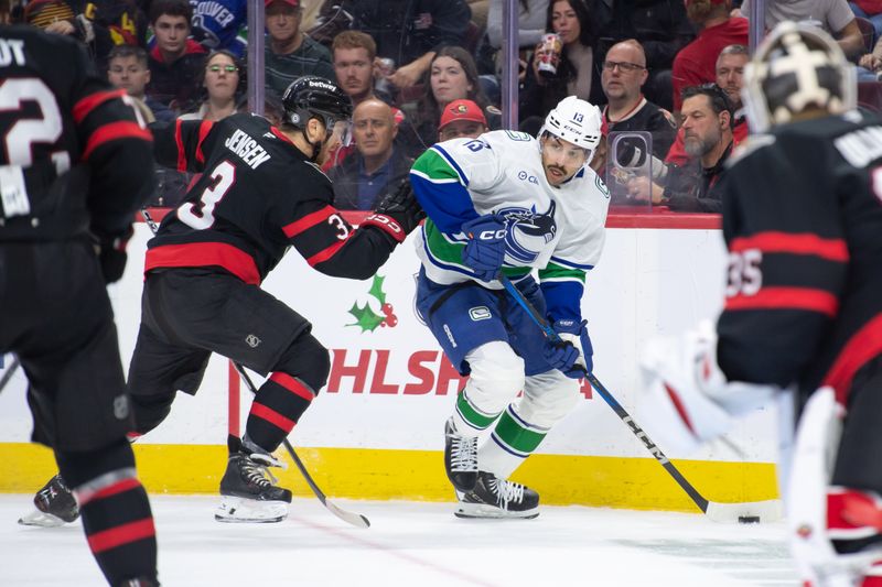 Nov 23, 2024; Ottawa, Ontario, CAN; Vancouver Canucks left wing Arshdeep Bains (13) controls the puck in the second period against the Ottawa Senators at the Canadian Tire Centre. Mandatory Credit: Marc DesRosiers-Imagn Images