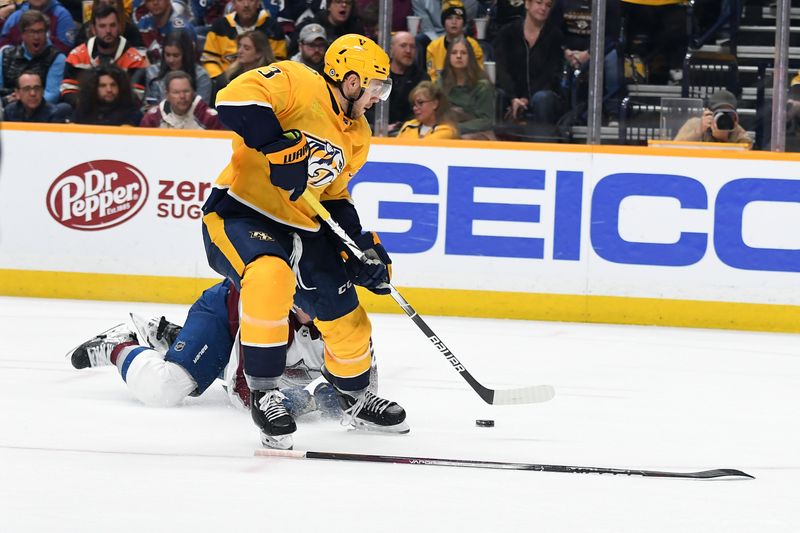 Mar 2, 2024; Nashville, Tennessee, USA; Nashville Predators defenseman Jeremy Lauzon (3) gets past Colorado Avalanche defenseman Josh Manson (42) for a scoring attempt during the third period at Bridgestone Arena. Mandatory Credit: Christopher Hanewinckel-USA TODAY Sports