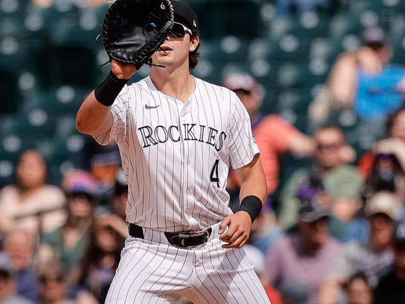 Apr 30, 2025; Denver, Colorado, USA; Colorado Rockies first baseman Michael Toglia (4) fields a throw for an out in the ninth inning against the Atlanta Braves at Coors Field. Mandatory Credit: Isaiah J. Downing-Imagn Images