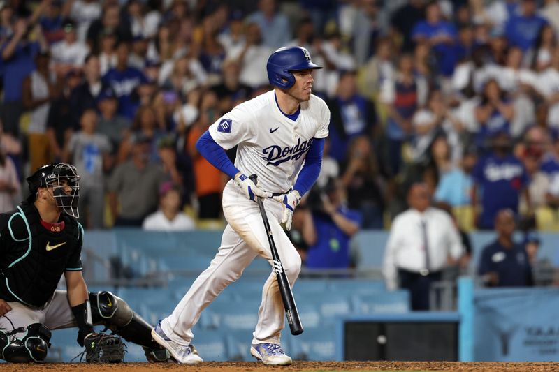 Jul 2, 2024; Los Angeles, California, USA;  Los Angeles Dodgers first baseman Freddie Freeman (5) hits an RBI double during the ninth inning against the Arizona Diamondbacks at Dodger Stadium. Mandatory Credit: Kiyoshi Mio-USA TODAY Sports