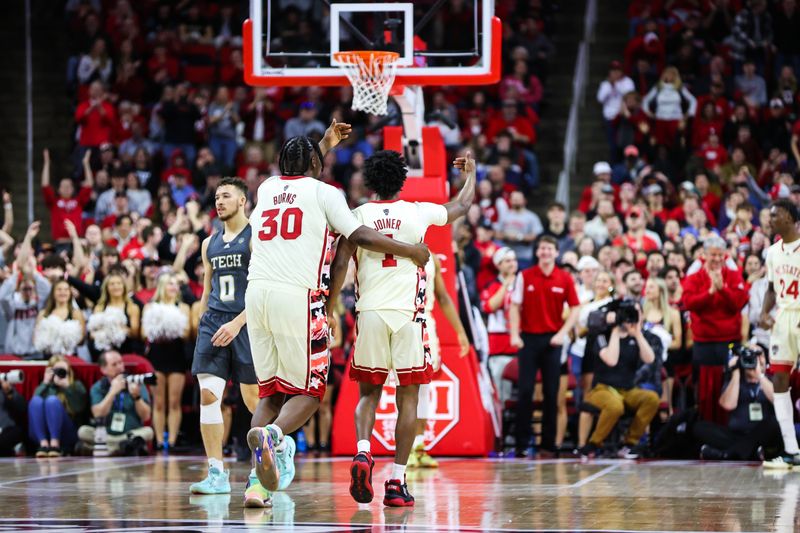 Feb 4, 2023; Raleigh, North Carolina, USA; North Carolina State Wolfpack forward D.J. Burns Jr. (30) and guard Jarkel Joiner (1) celebrate a win during the second half of the game against Georgia Tech Yellow Jackets at PNC Arena. Mandatory Credit: Jaylynn Nash-USA TODAY Sports