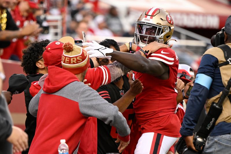 San Francisco 49ers safety Malik Mustapha, right, celebrates with fans during the first half of an NFL football game against the Dallas Cowboys in Santa Clara, Calif., Sunday, Oct. 27, 2024. (AP Photo/Eakin Howard)