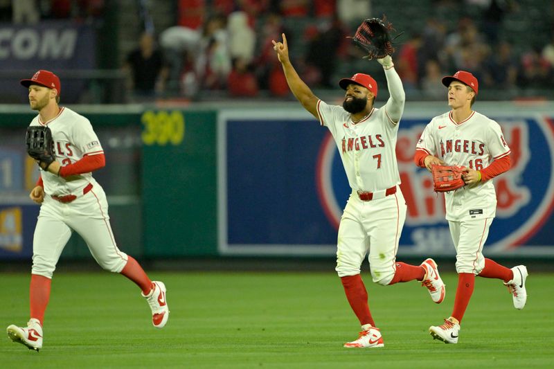 Jun 4, 2024; Anaheim, California, USA;  Los Angeles Angels left fielder Taylor Ward (3), right fielder Jo Adell (7), and center fielder Mickey Moniak (16) celebrate after the final out of ninth inning against the San Diego Padres at Angel Stadium. Mandatory Credit: Jayne Kamin-Oncea-USA TODAY Sports