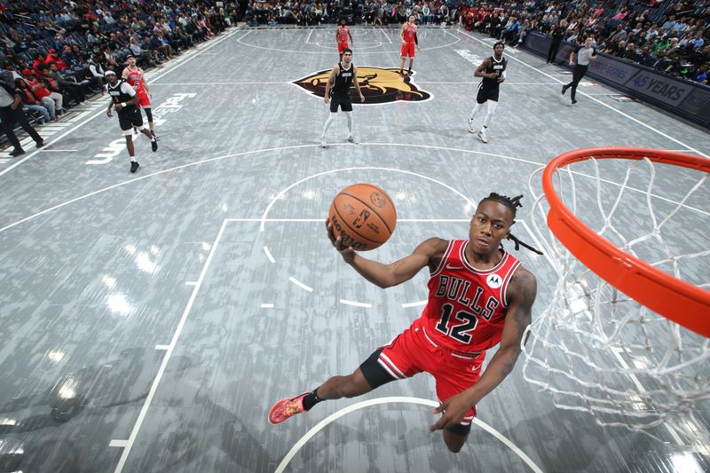 MEMPHIS, TN - FEBRUARY 8: Ayo Dosunmu #12 of the Chicago Bulls drives to the basket during the game against the Memphis Grizzlies on February 8, 2024 at FedExForum in Memphis, Tennessee. NOTE TO USER: User expressly acknowledges and agrees that, by downloading and or using this photograph, User is consenting to the terms and conditions of the Getty Images License Agreement. Mandatory Copyright Notice: Copyright 2024 NBAE (Photo by Joe Murphy/NBAE via Getty Images)